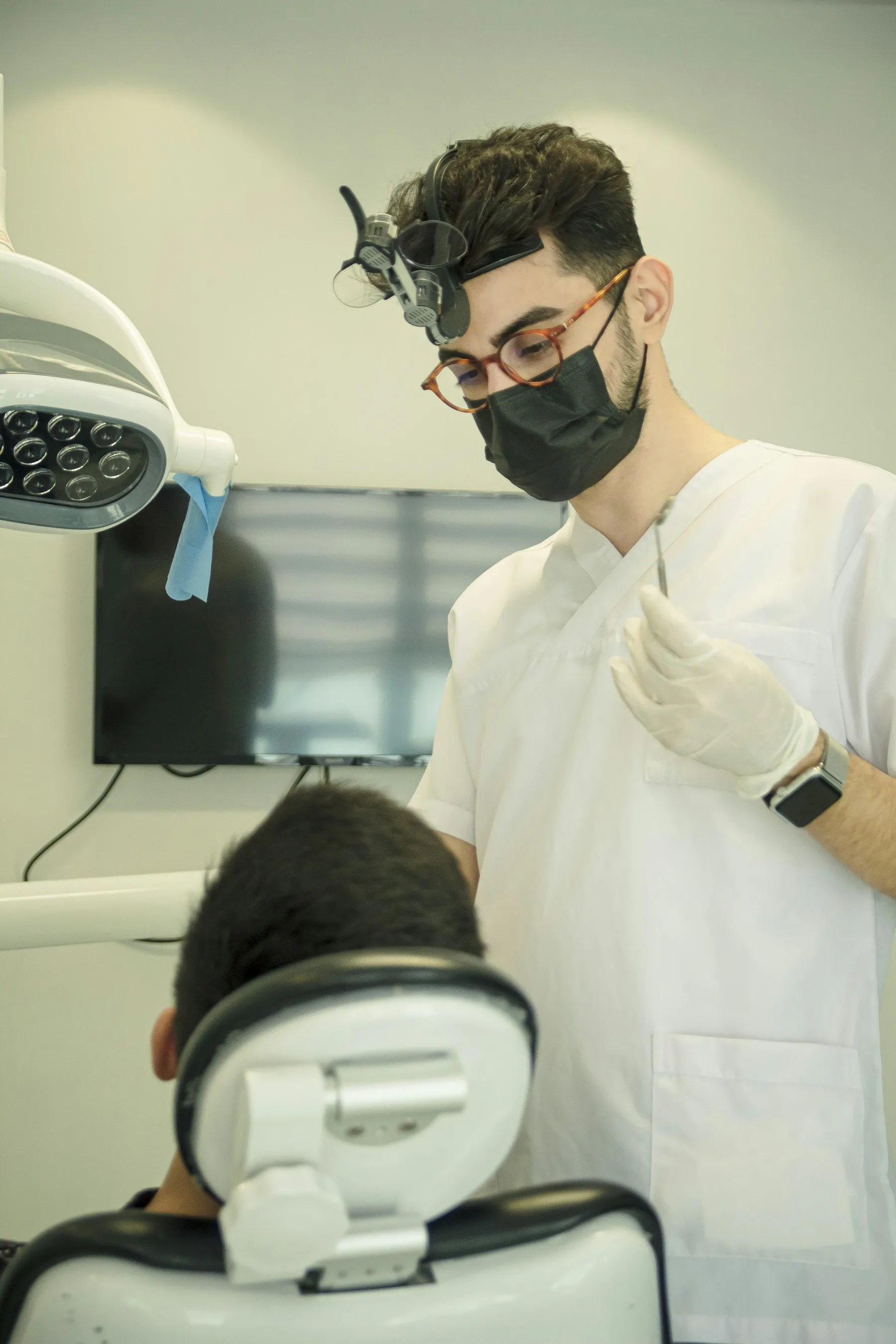 A dentist carrying out a detailed clinical examination